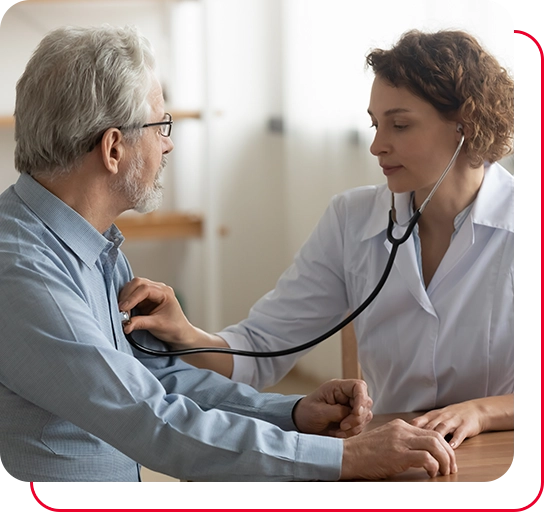 Caring Caucasian female doctor use phonendoscope examine mature male patient heart rate at consultation in hospital.